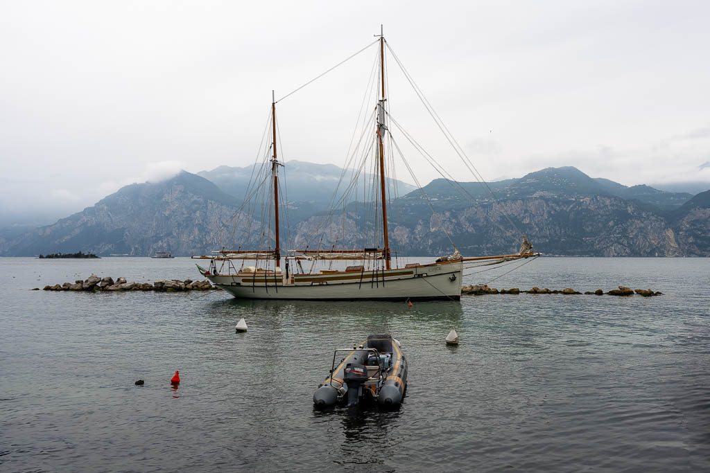 Eine Motorboot vor einem Segelboot in Malcesine